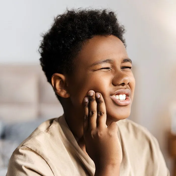 Child wearing a mouthguard to prevent tooth injuries